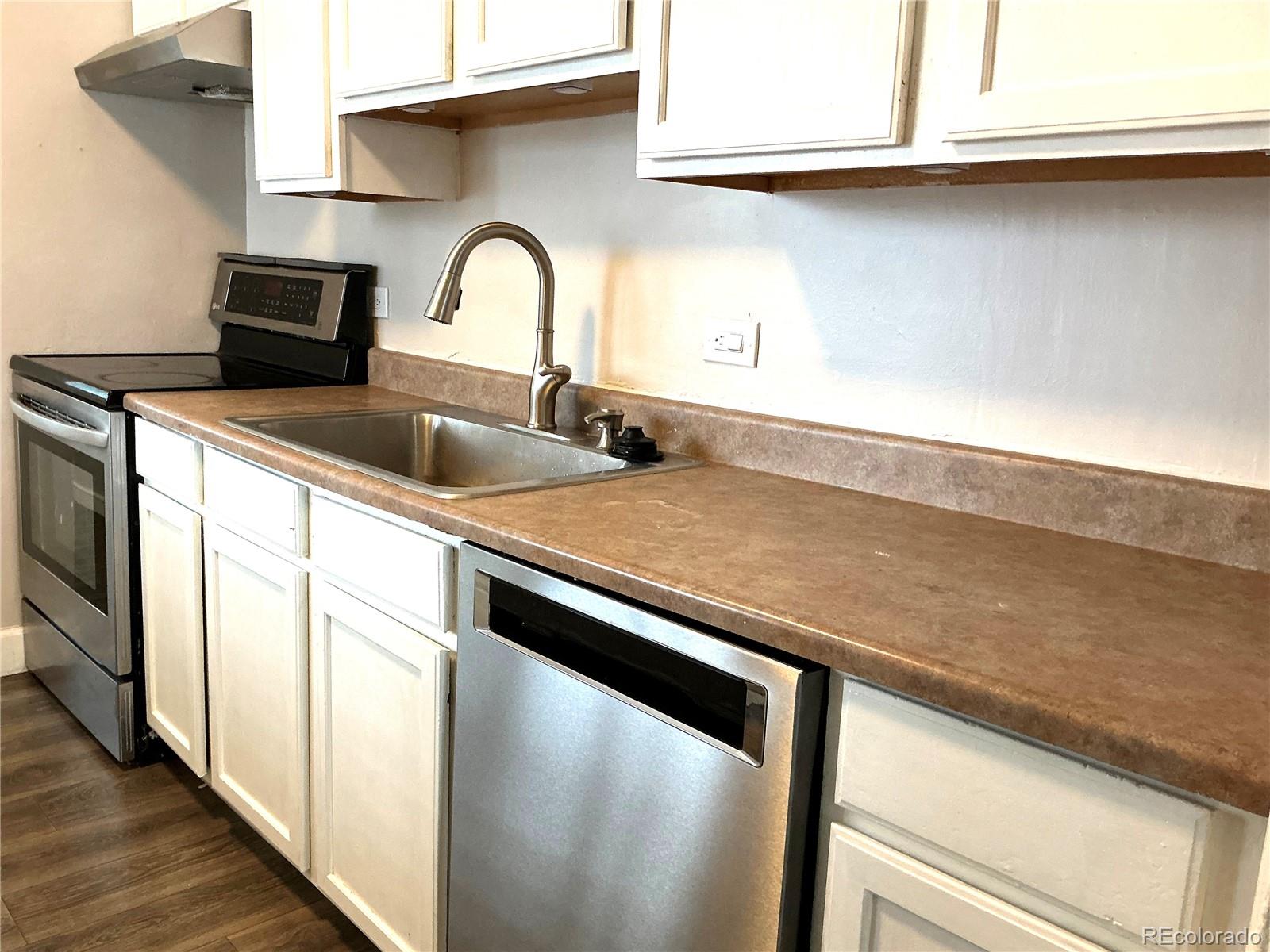 Undisclosed Address Aurora, CO 80010 - Photo 4 of 23 a close view of a sink and a microwave in a kitchen