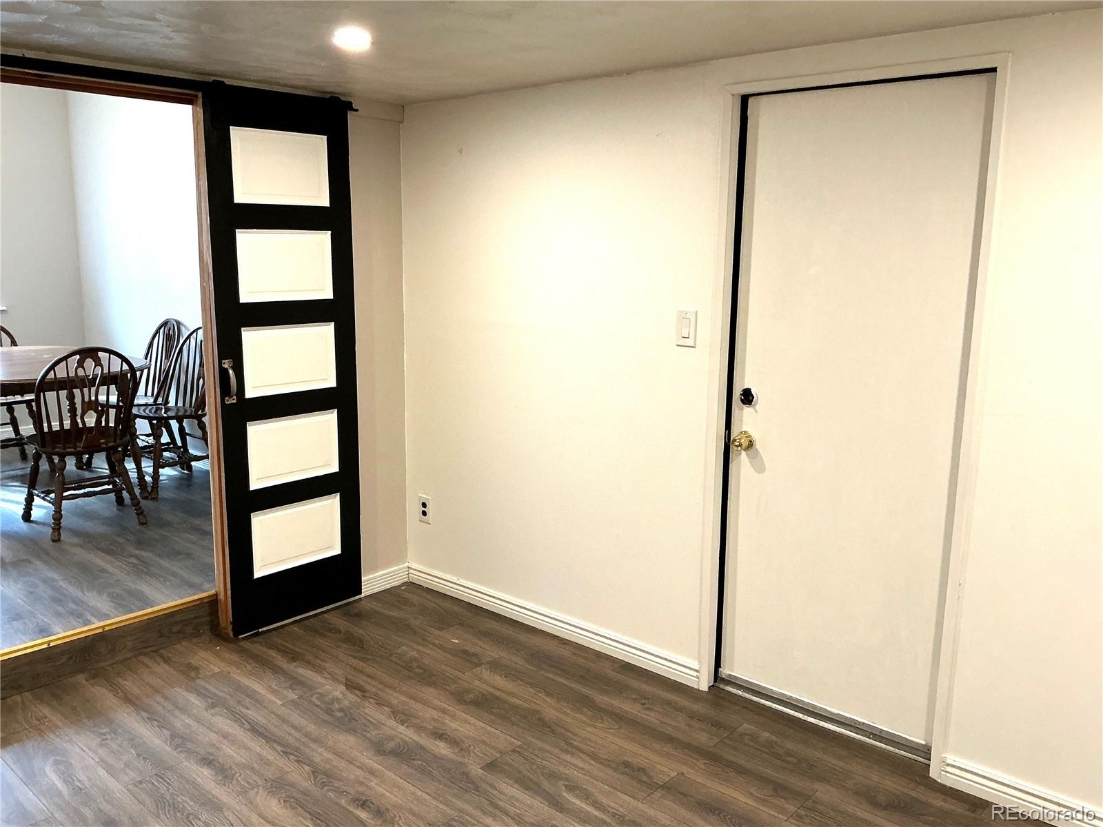 Undisclosed Address Aurora, CO 80010 - Photo 8 of 23 an empty room with wooden floor and windows