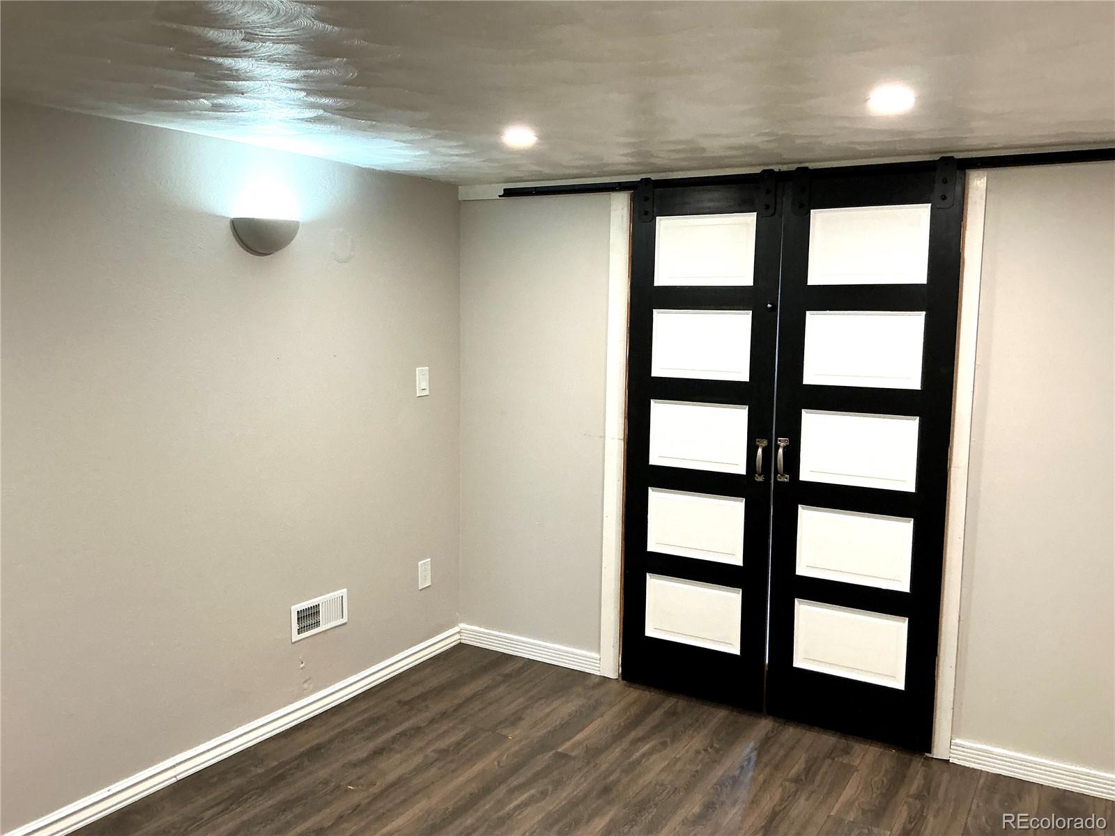 Undisclosed Address Aurora, CO 80010 - Photo 9 of 23 an empty room with wooden floor and windows