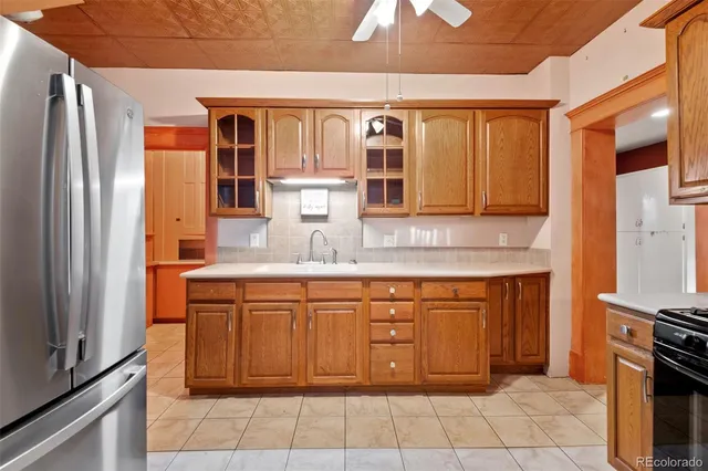 a kitchen with stainless steel appliances granite countertop a refrigerator and a sink