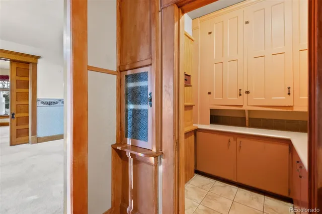 a view of a house with a door and wooden cabinets