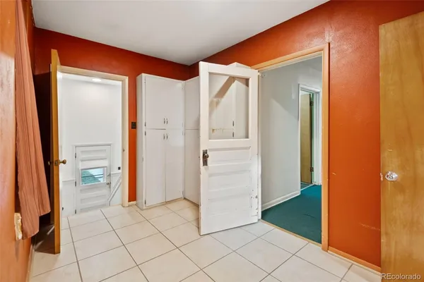 a view of a room that has a window and chair in it