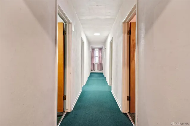 a room with a window and a dresser