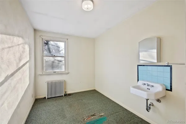 a bathroom with a sink a mirror and a window