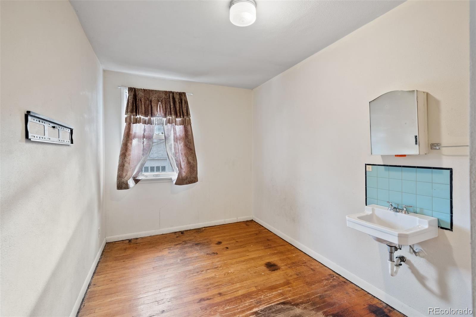 303 South 3rd Street Sterling, CO 80751 - Photo 26 of 50 a bathroom with a sink and a mirror