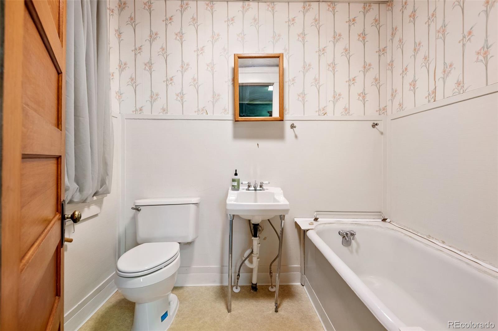 303 South 3rd Street Sterling, CO 80751 - Photo 30 of 50 a bathroom with a sink a toilet and a bathtub