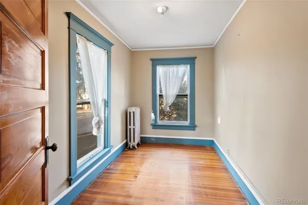 a view of a hallway with wooden shelves and windows