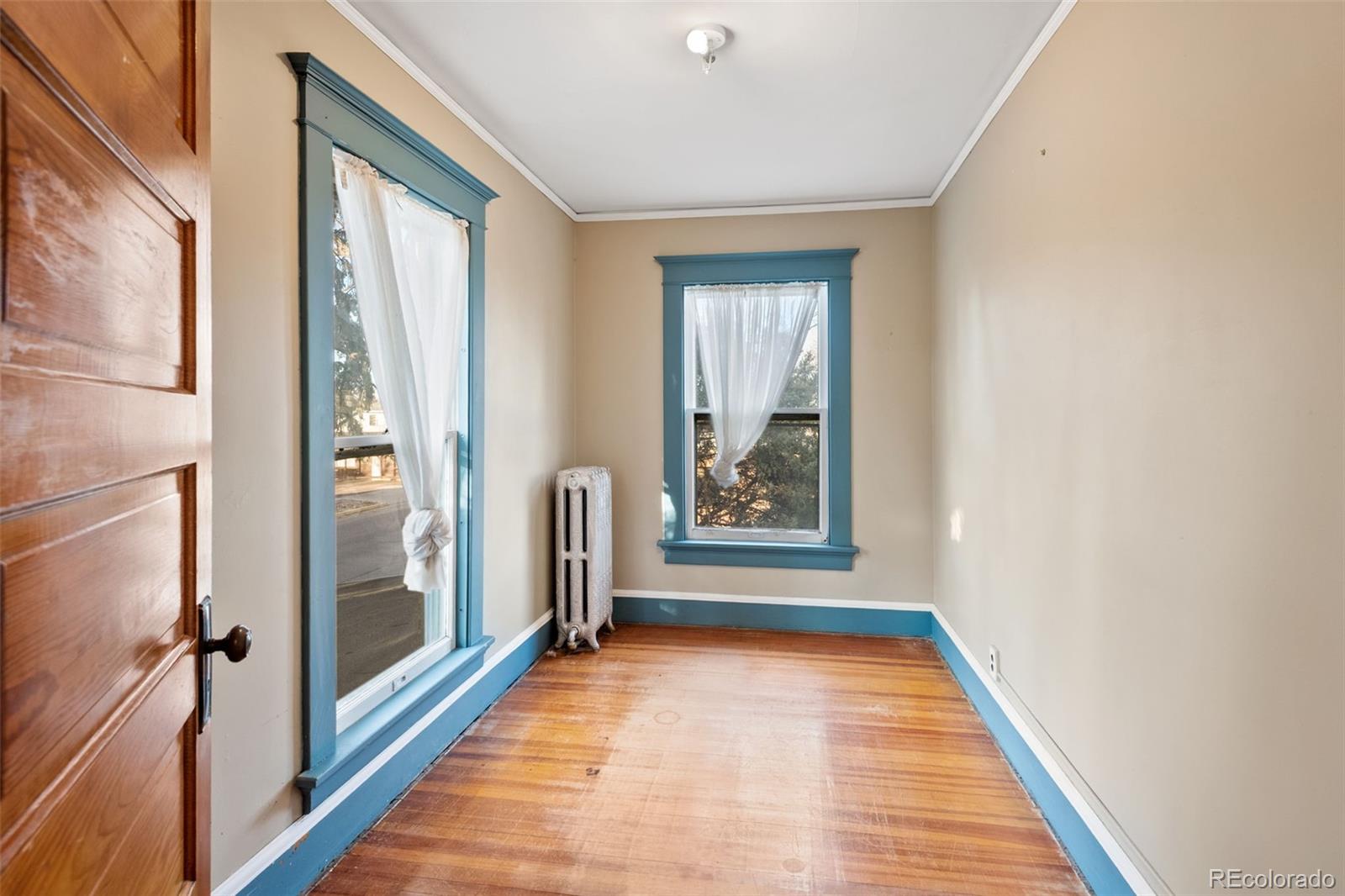 303 South 3rd Street Sterling, CO 80751 - Photo 33 of 50 a view of a hallway with wooden floor and a living room