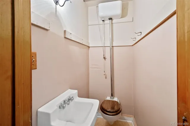 a bathroom with a sink a toilet a mirror and shower