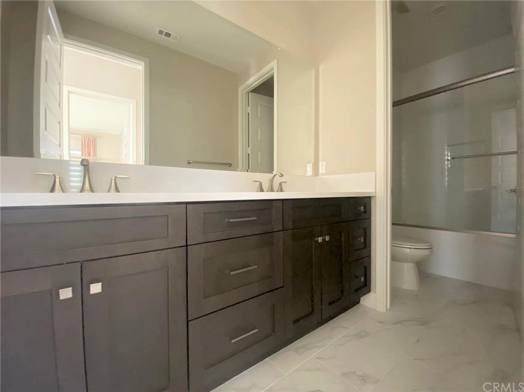 114 Spiral Irvine, CA 92618 - Photo 5 of 15 a bathroom with a double vanity sink mirror and toilet