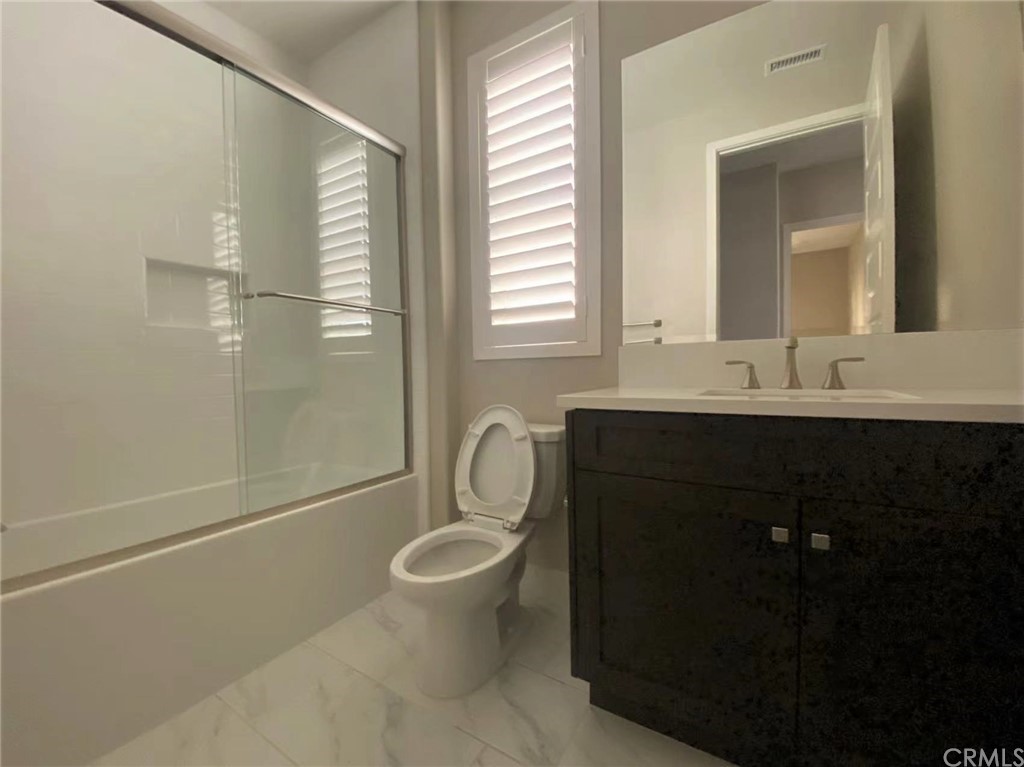 114 Spiral Irvine, CA 92618 - Photo 7 of 15 a bathroom with a granite countertop sink toilet and shower