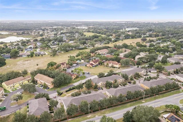 an aerial view of residential building and lake