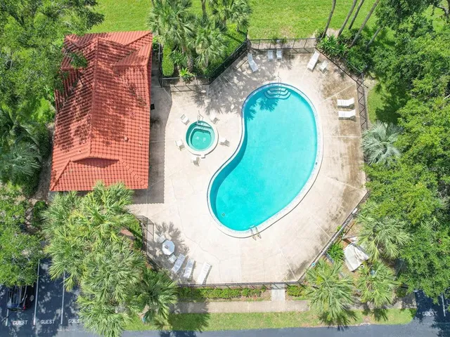 an aerial view of a house with swimming pool and outdoor space