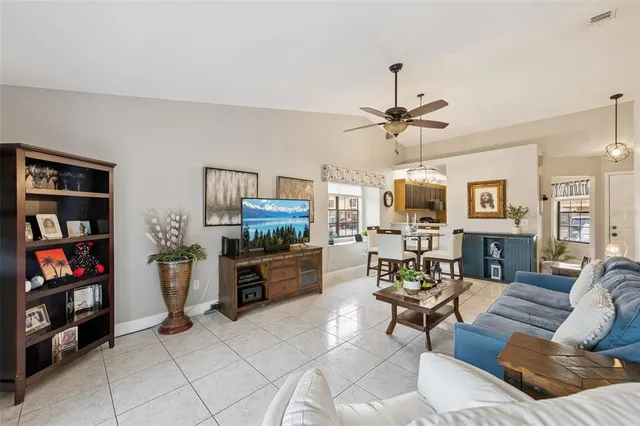 a living room with furniture a flat screen tv and a bookshelf