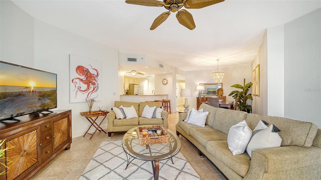 14041 Bellagio Way, Unit 316 Osprey, FL 34229 - Photo 12 of 74 a living room with furniture and a flat screen tv