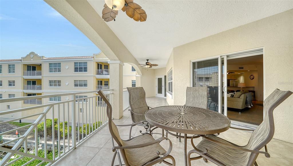 14041 Bellagio Way, Unit 316 Osprey, FL 34229 - Photo 15 of 74 a view of a dining room with furniture and a chandelier