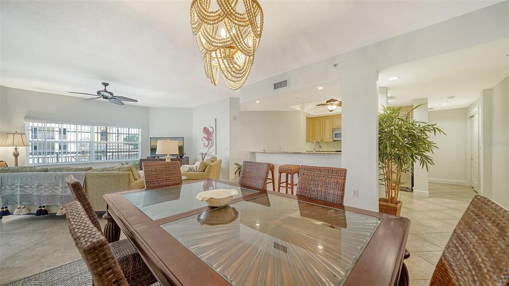 14041 Bellagio Way, Unit 316 Osprey, FL 34229 - Photo 19 of 74 a view of a dining room with furniture window and wooden floor