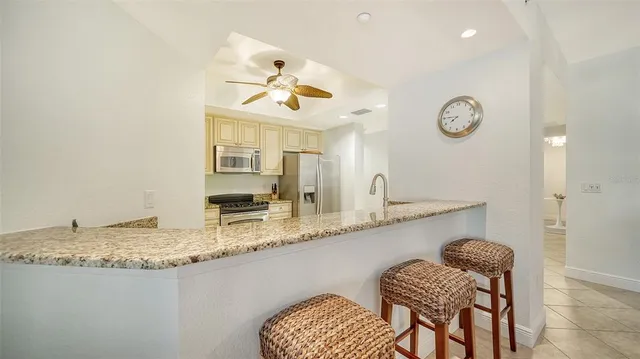 a kitchen with granite countertop cabinets and steel stainless steel appliances