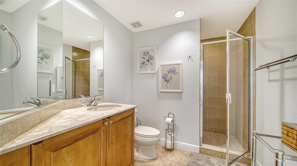 14041 Bellagio Way, Unit 316 Osprey, FL 34229 - Photo 39 of 74 a bathroom with a granite countertop sink toilet and shower