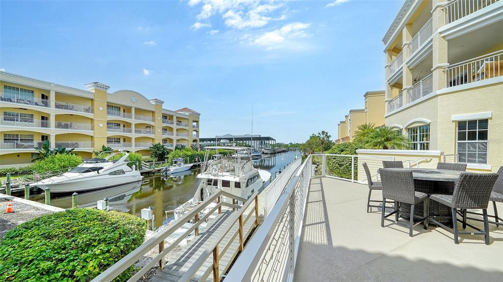 14041 Bellagio Way, Unit 316 Osprey, FL 34229 - Photo 45 of 74 a view of a patio with couches table and chairs and potted plants