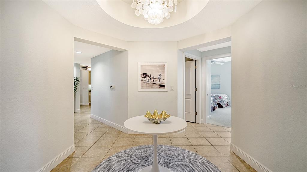 14041 Bellagio Way, Unit 316 Osprey, FL 34229 - Photo 7 of 74 a view of a livingroom with table and chair