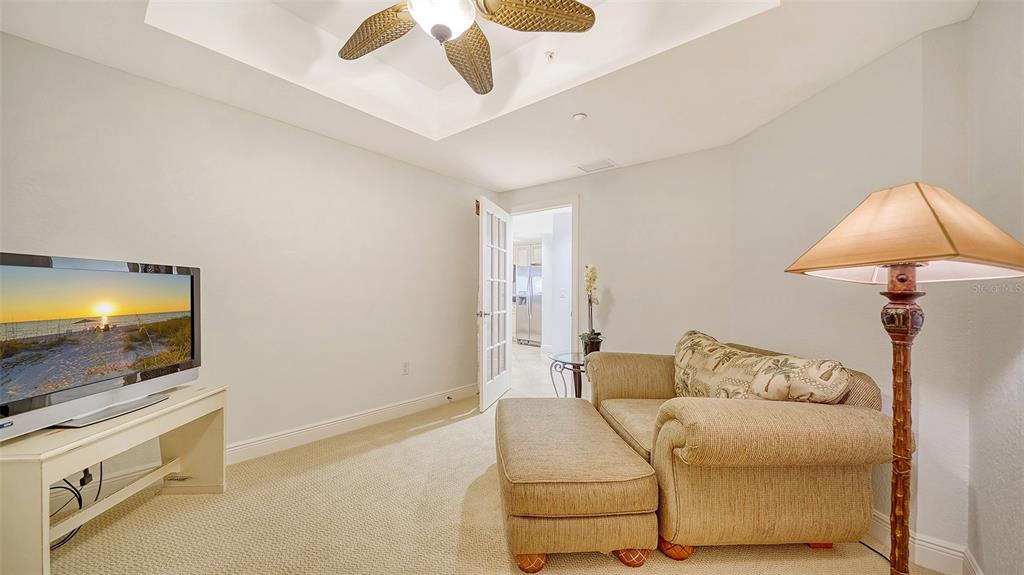 14041 Bellagio Way, Unit 316 Osprey, FL 34229 - Photo 9 of 74 a living room with furniture and a flat screen tv