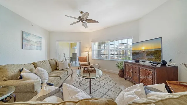 a living room with furniture and a flat screen tv with wooden floor