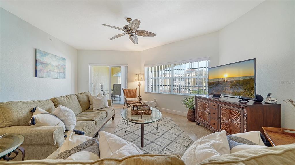 14041 Bellagio Way, Unit 316 Osprey, FL 34229 - Photo 10 of 74 a living room with furniture and a flat screen tv