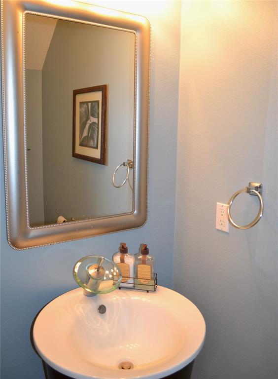 11158 Kapok Grand Circle Madeira Beach, FL 33708 - Photo 11 of 48 a bathroom with a sink and mirror