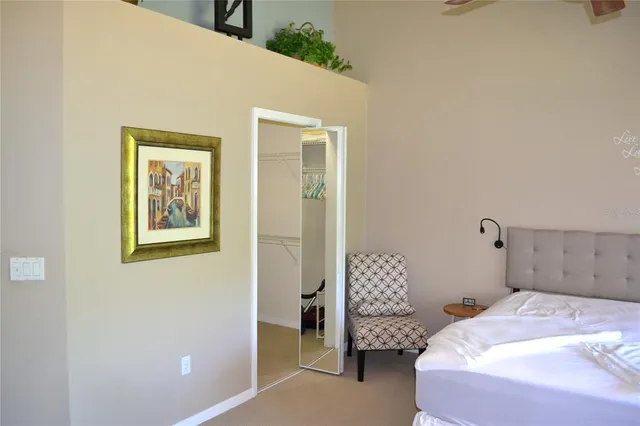 a bedroom with a bed and a chandelier