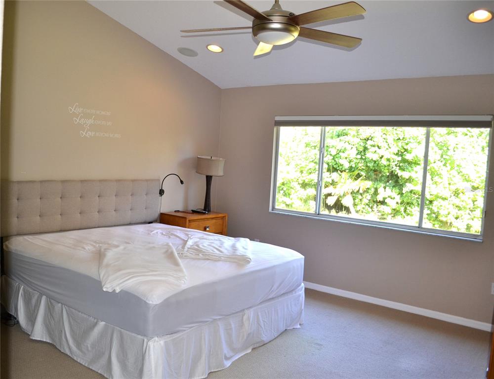 11158 Kapok Grand Circle Madeira Beach, FL 33708 - Photo 17 of 48 a bedroom with a bed and a window
