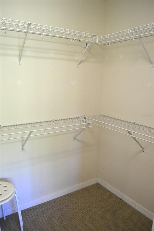 11158 Kapok Grand Circle Madeira Beach, FL 33708 - Photo 23 of 48 a view of a room with racks on the wall