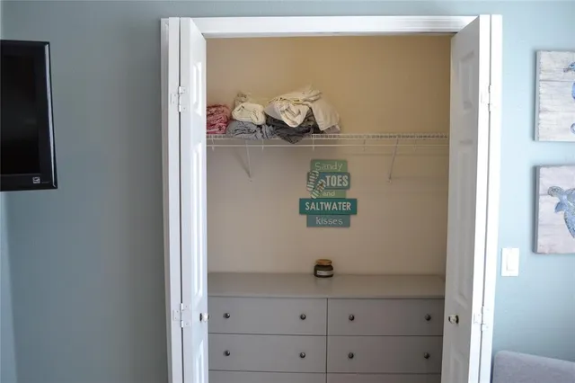 a living room with patio furniture and a garden