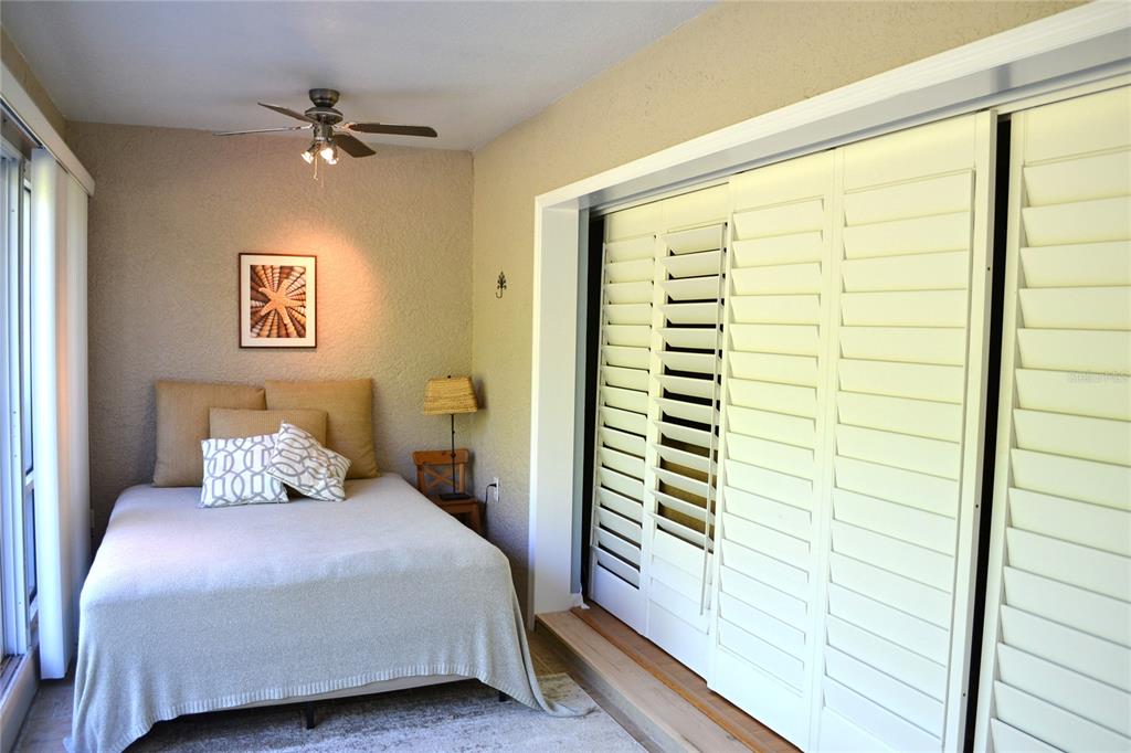 11158 Kapok Grand Circle Madeira Beach, FL 33708 - Photo 31 of 48 a bedroom with a bed and a window