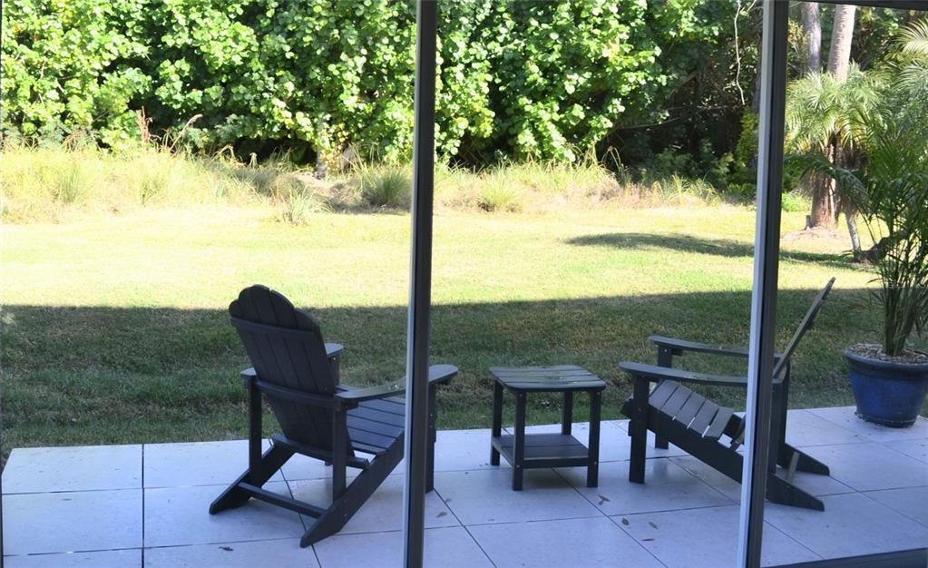 11158 Kapok Grand Circle Madeira Beach, FL 33708 - Photo 34 of 48 a view of an outdoor sitting area with furniture and garden