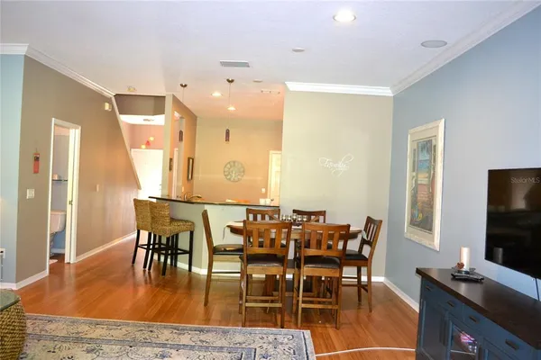 a dining room with furniture and wooden floor