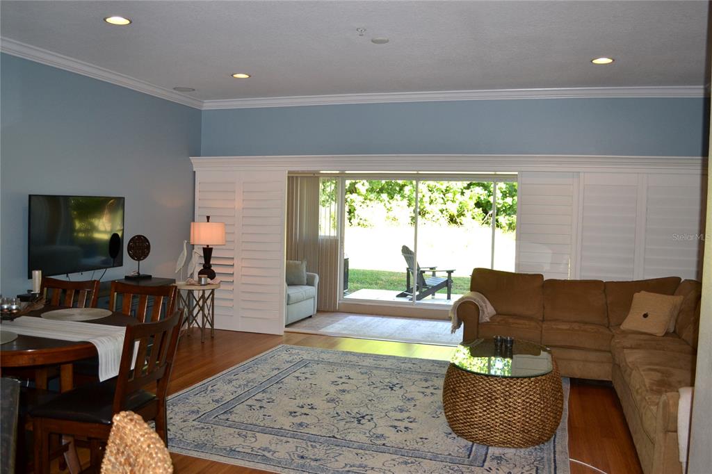11158 Kapok Grand Circle Madeira Beach, FL 33708 - Photo 9 of 48 a living room with furniture and a flat screen tv