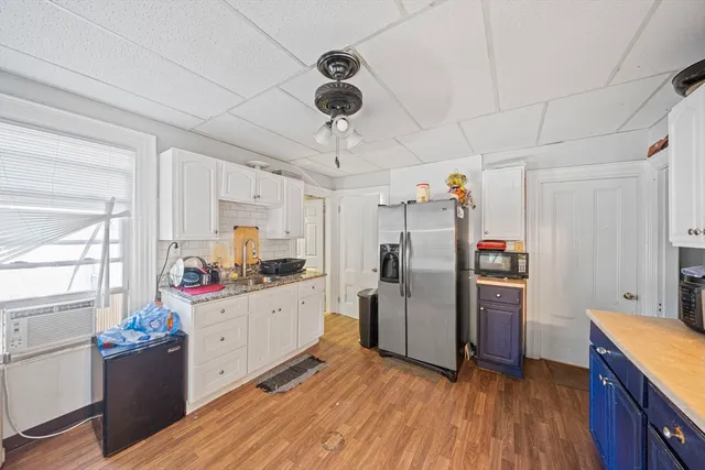 a kitchen with stainless steel appliances a stove refrigerator and microwave