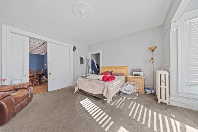 a bedroom with furniture and a window