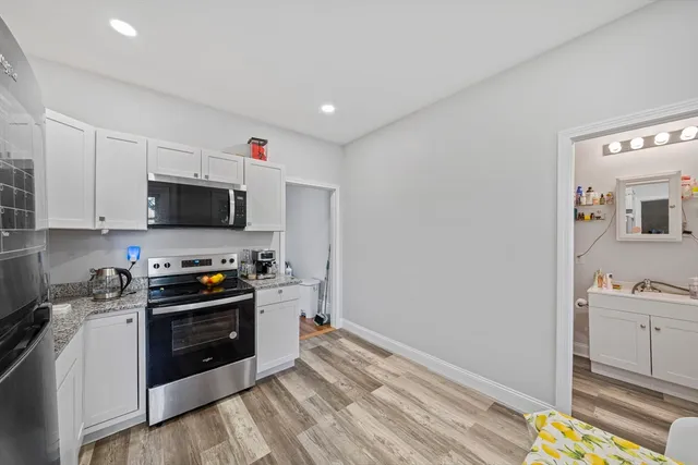 a kitchen with a sink and steel appliances