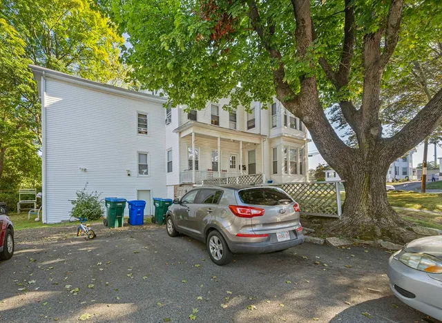 a car parked in front of white house
