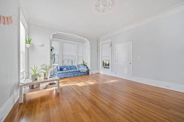 a view of an empty room and wooden floor