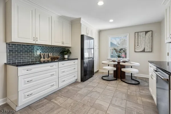 a kitchen with a white stove top oven and white cabinets