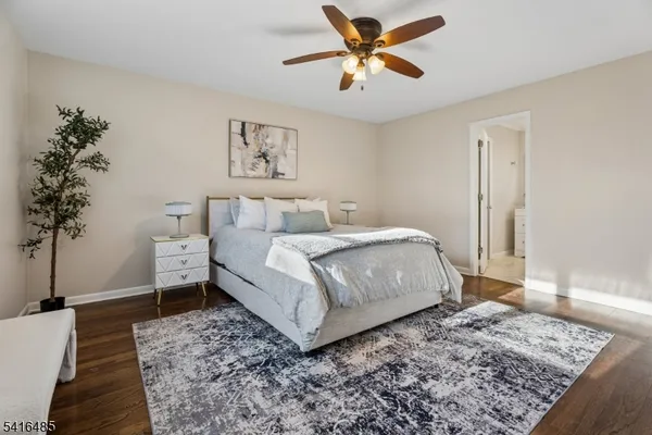 a bedroom with a large bed and a potted plant
