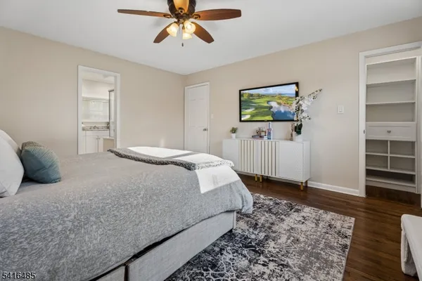 a bedroom with a bed and a painting on the wall