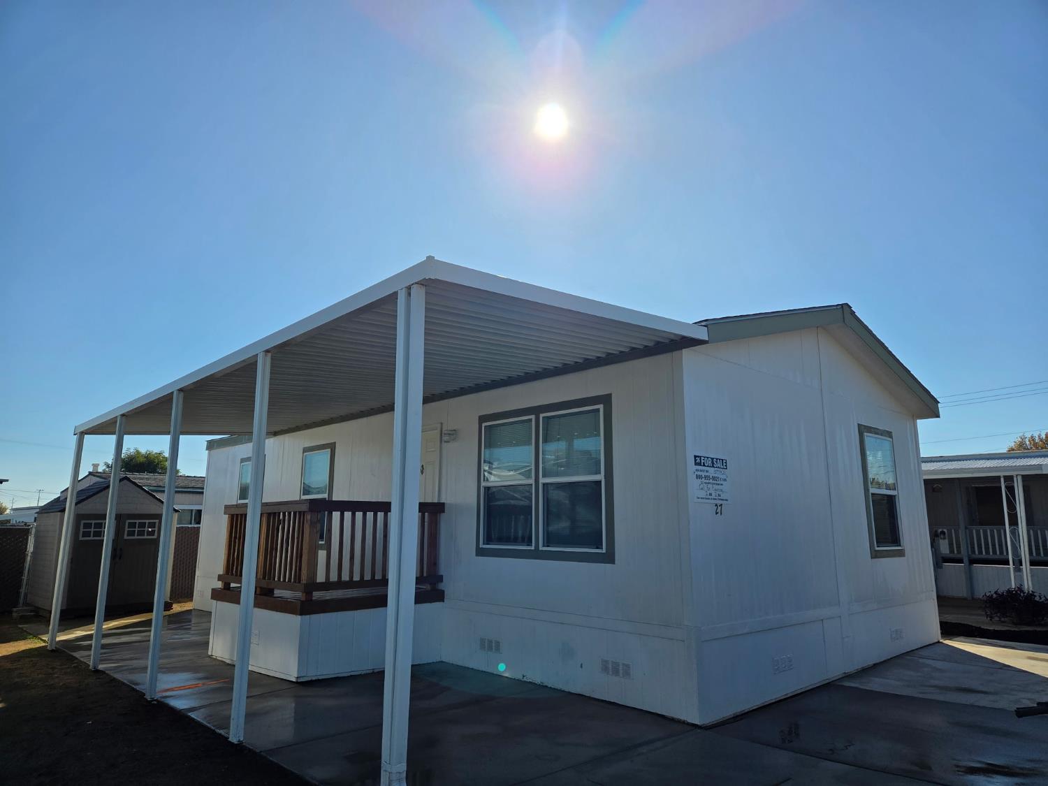 a backyard of a house with barbeque oven and glass door