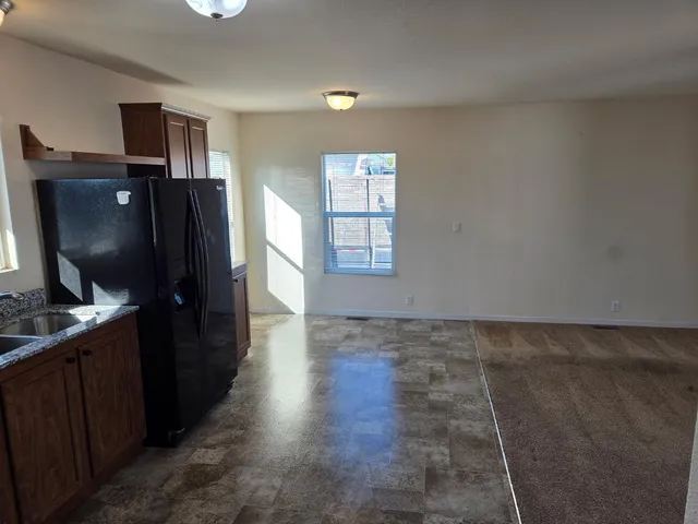 a kitchen with granite countertop a refrigerator and a stove