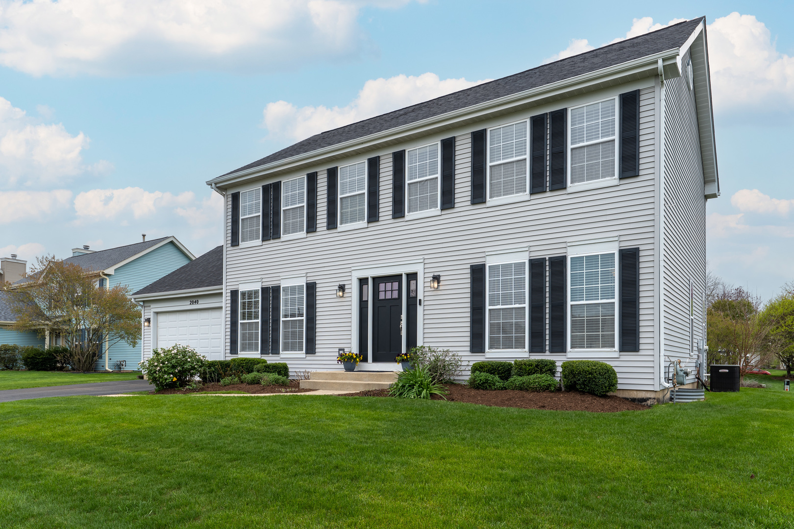 a front view of a house with a garden