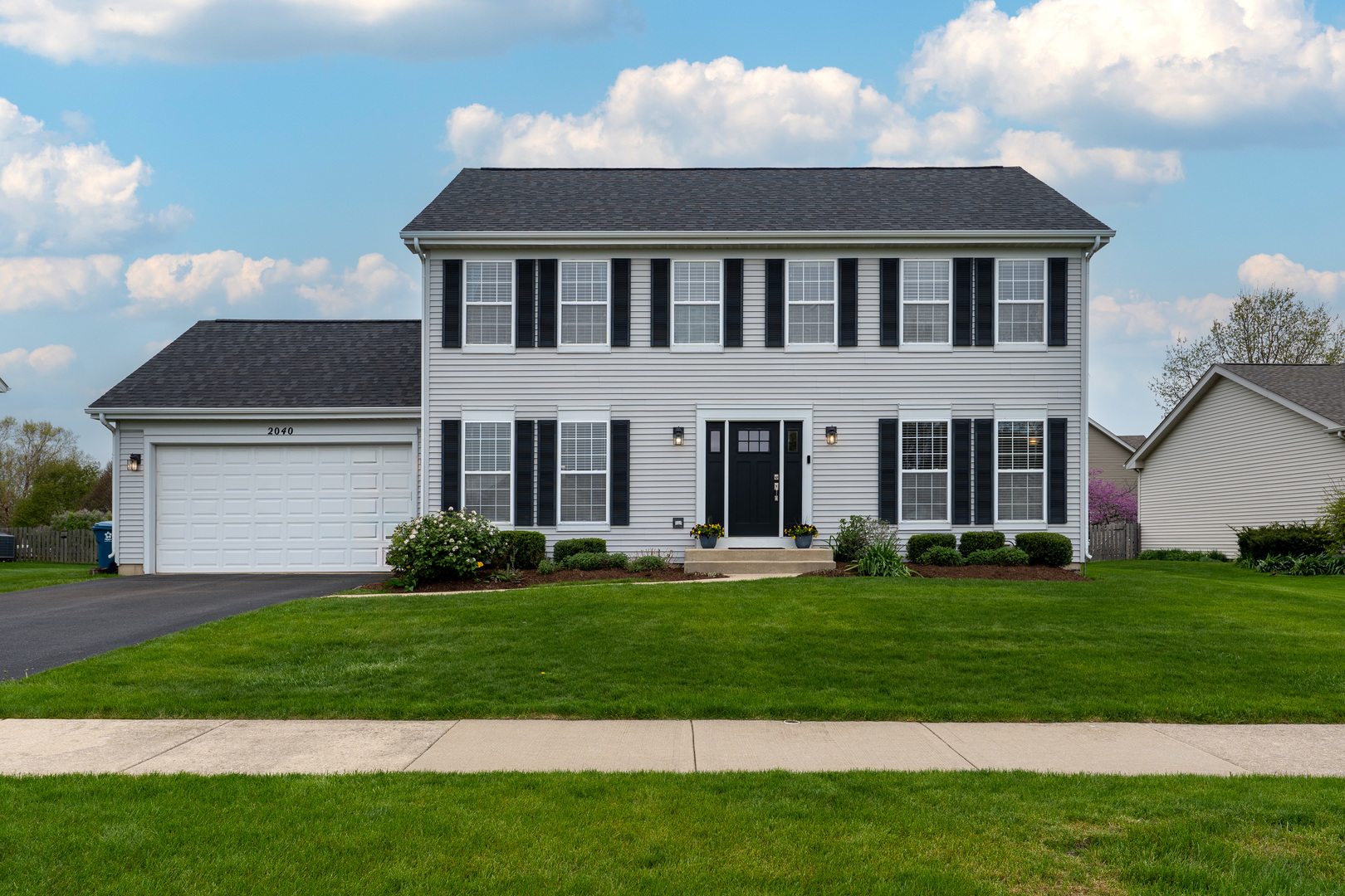 2040 Garfield Avenue Aurora, IL 60506 - Photo 2 of 32 a front view of a house with a yard