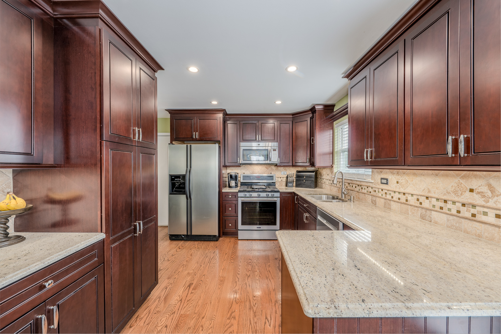 2040 Garfield Avenue Aurora, IL 60506 - Photo 6 of 32 a modern kitchen with granite countertop stainless steel appliances and wooden cabinets